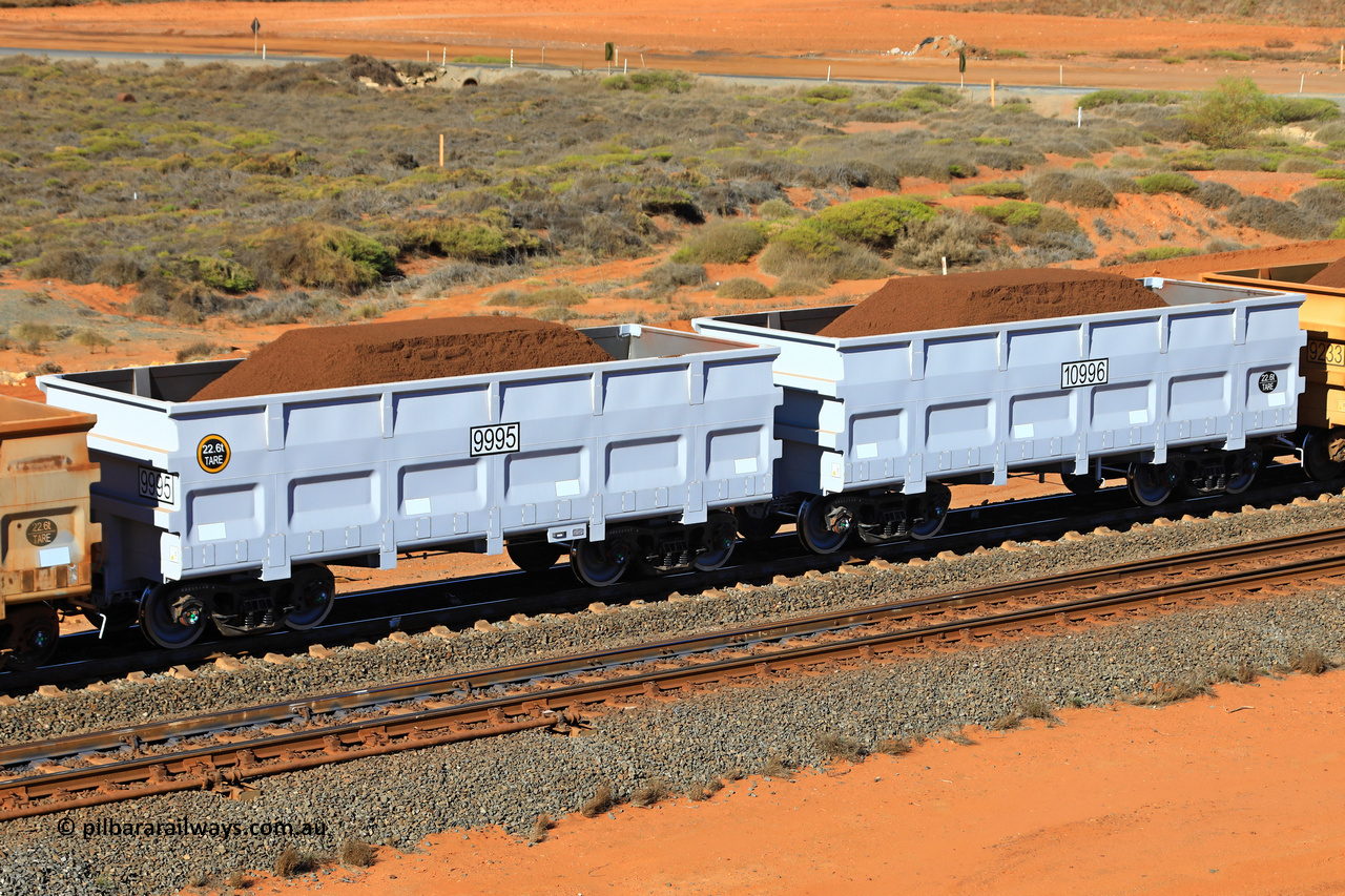 09995-10996 240622 2929
FMG 9995 and 10996 on a loaded train at Kanyirri Yard, June 22, 2024. 338 waggons numbered from 9659 slave and 10660 control, up to 9995 slave and 10996 control built by CRRC Qiqihar in 2023 and 2024, with the CNR style body at 22.5 tonne tare.
Keywords: 9995-10996;CRRC-Qiqihar;FMG-ore-waggon;